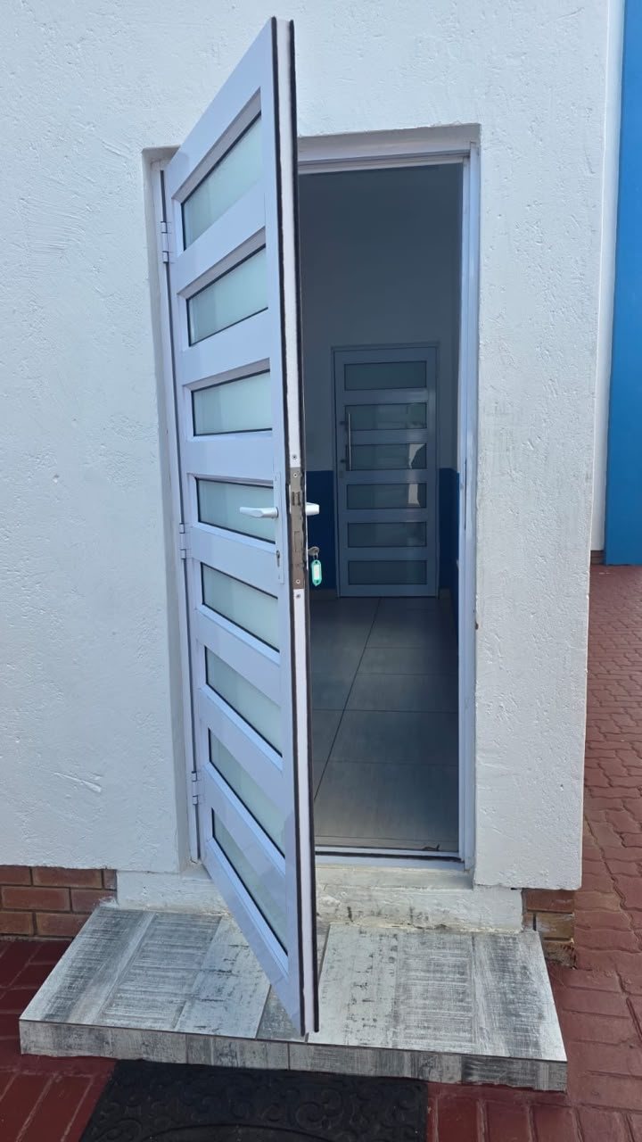 Aluminium pedestrian door standing open