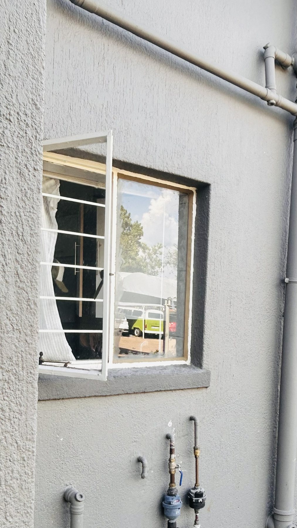 Aluminium window with burglar bars installed