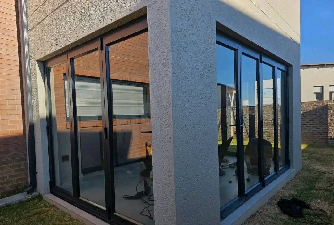 Black aluminium corner windows and sliding doors