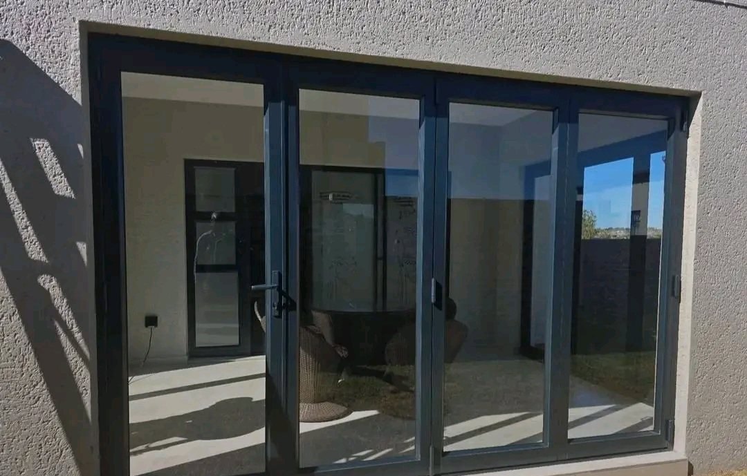 Large black aluminium sliding door opening