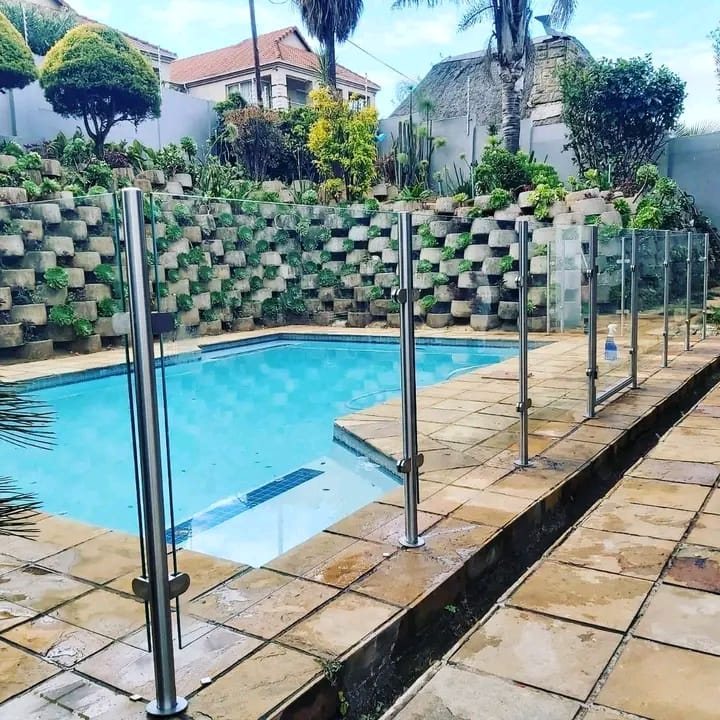 Frameless glass pool fence in a garden