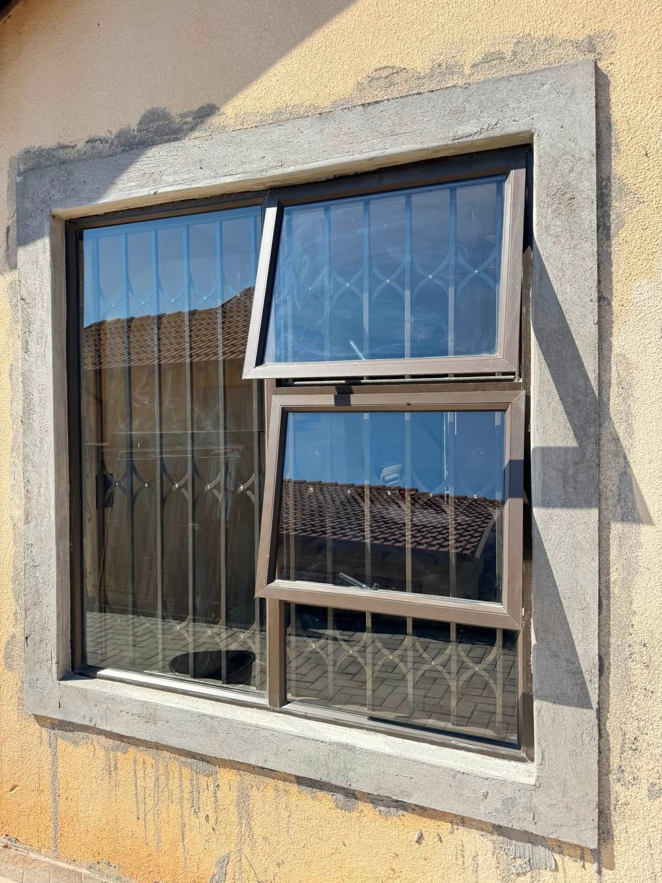 Top hung aluminium windows fitted with burglar bars